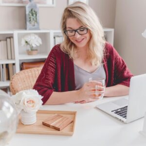 Woman smiling while working at her laptop