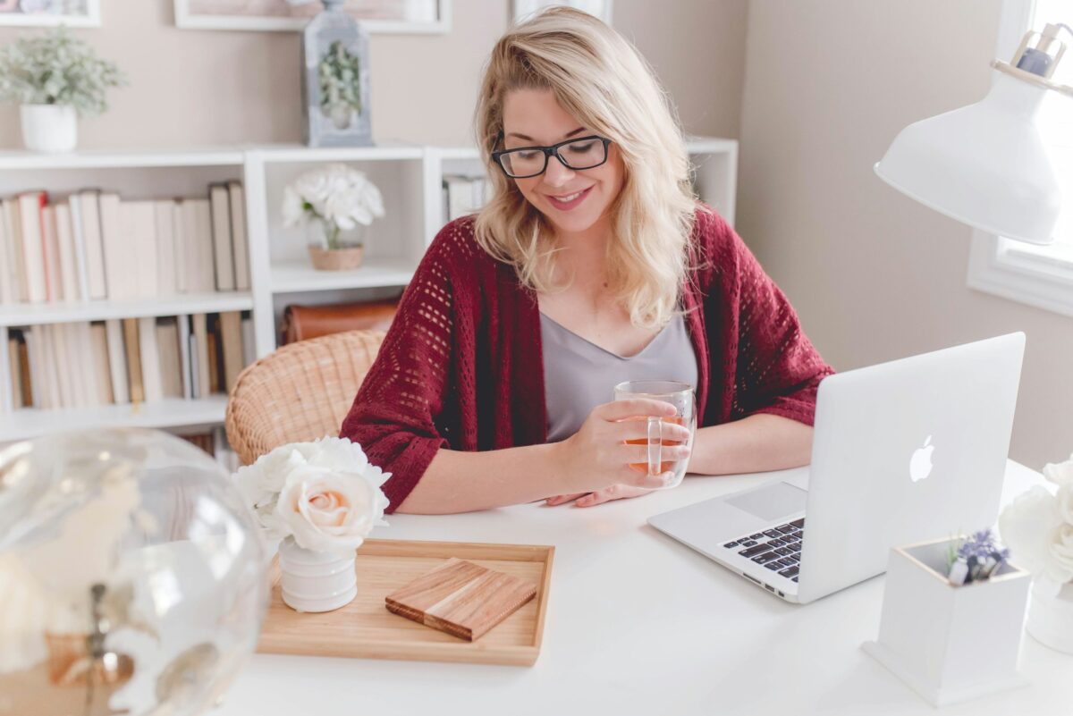 Woman smiling while working at her laptop