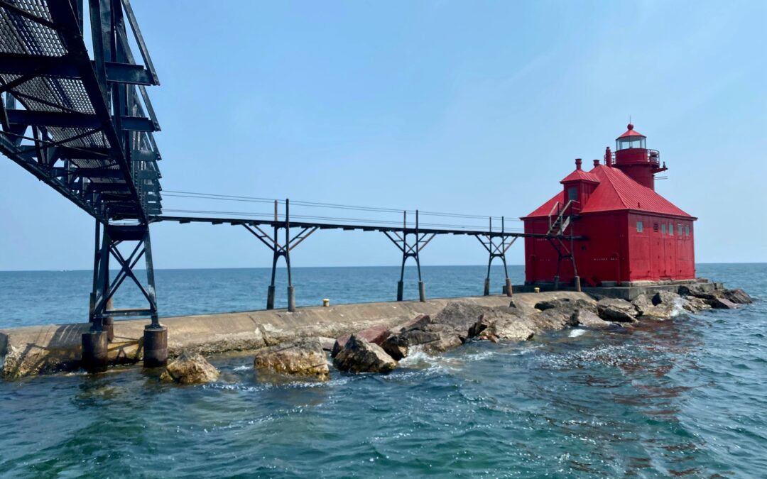 Angled photo of the Coast Guard walkway and red lighthouse in Sturgeon Bay, Wisconsin