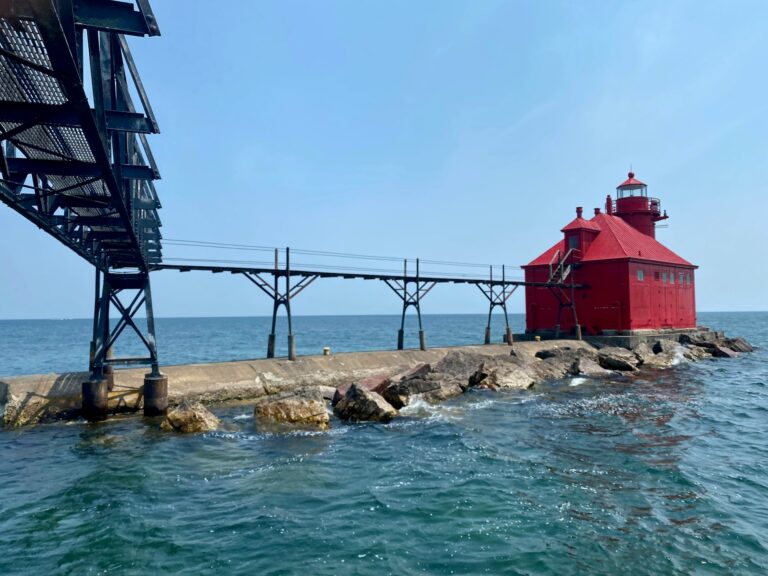 Angled photo of the Coast Guard walkway and red lighthouse in Sturgeon Bay, Wisconsin
