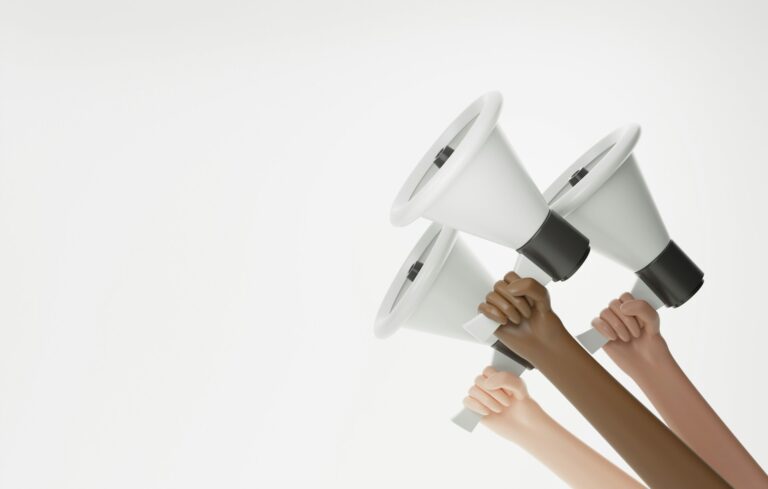 hands holding up megaphones